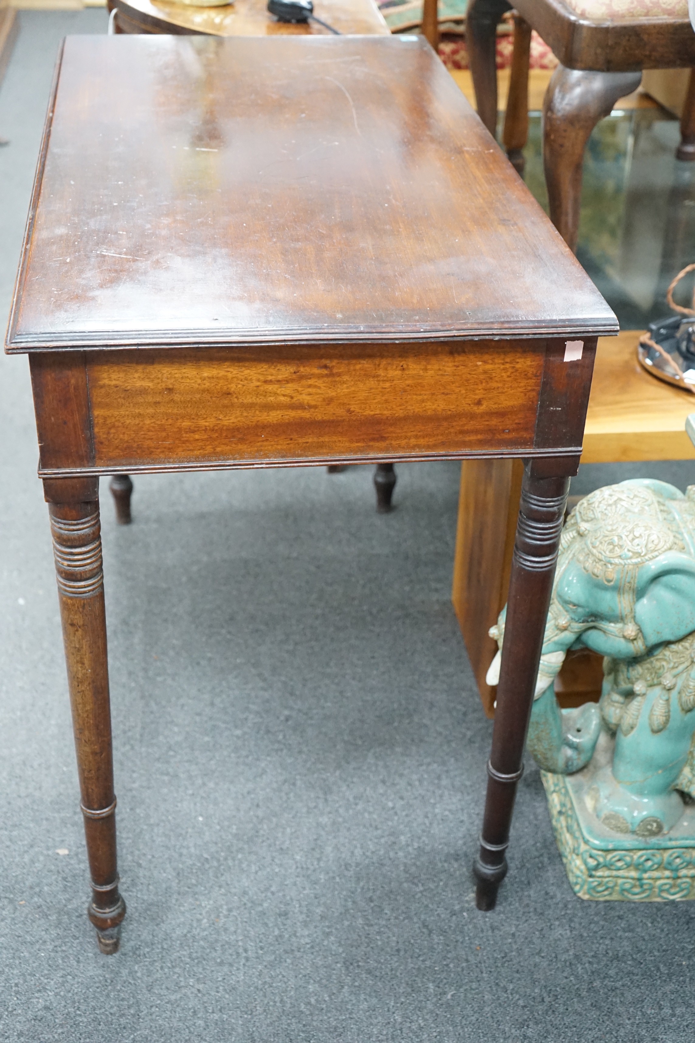 A Regency mahogany two drawer side table with moulded edge on turned legs, width 95cm, depth 51cm, height 78cm